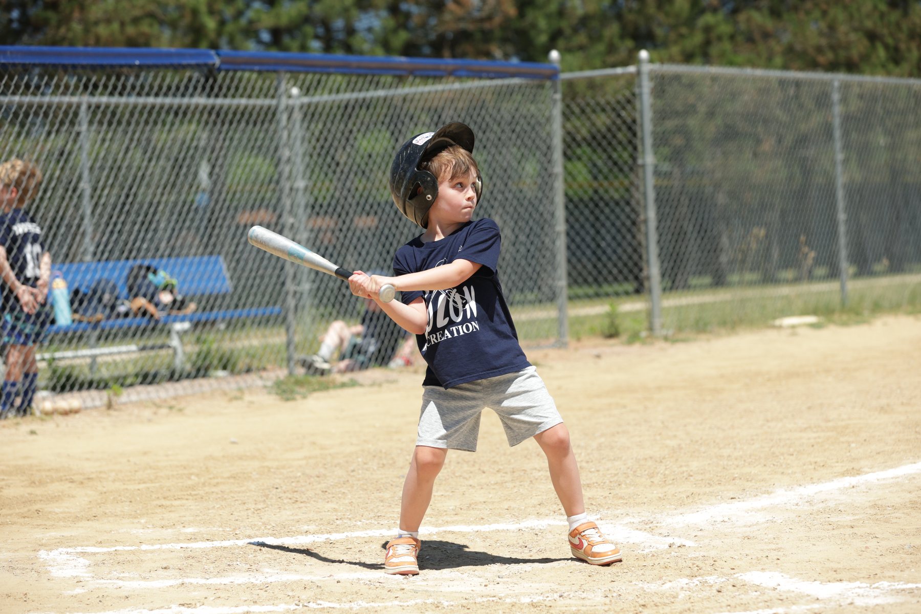 Youth baseball player swinging at the plate.