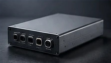 Brushed-aluminum electronics enclosure with front-panel connectors.