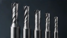 Row of carbide end mills in descending sizes.