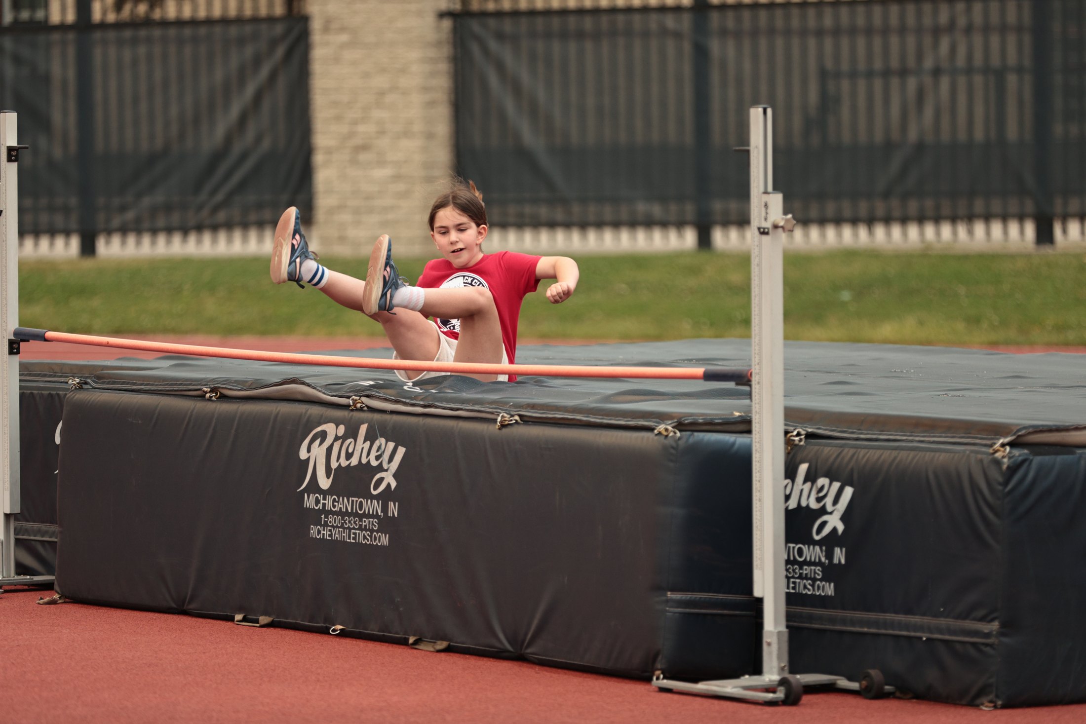 High jump action during a track event.
