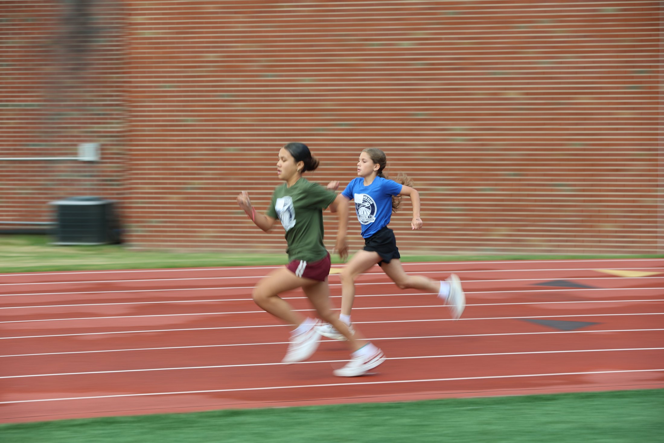 Two runners sprinting on a track.